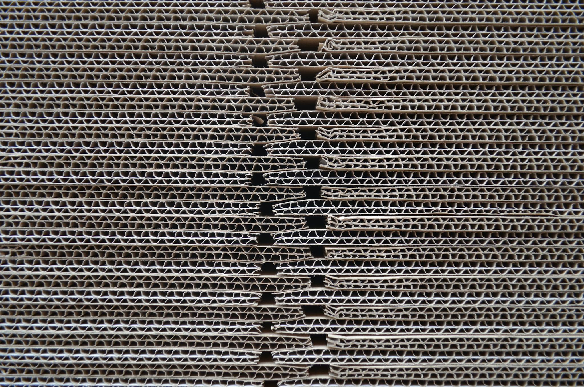 Detailed close-up of corrugated cardboard stack showcasing its wavy texture and pattern.
